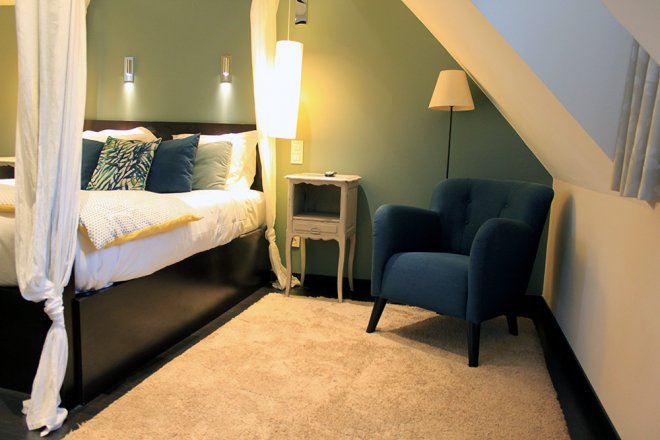 superieur-duplex-chambre-hotel-coussin-dessus-lit-baldaquin-fauteuil-bleu
